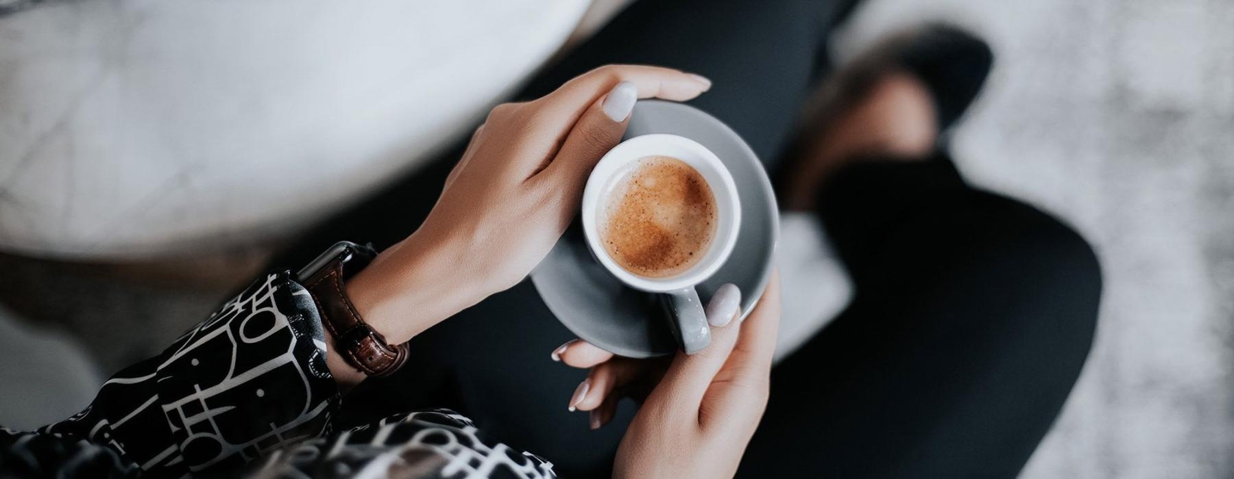 Businesswoman enjoys espresso at Perimeter Pointe apartments near the Charlotte Airport