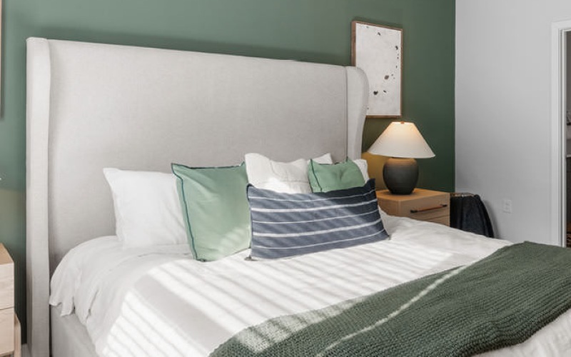 Contemporary bedroom with large window at Perimeter Pointe luxury apartments