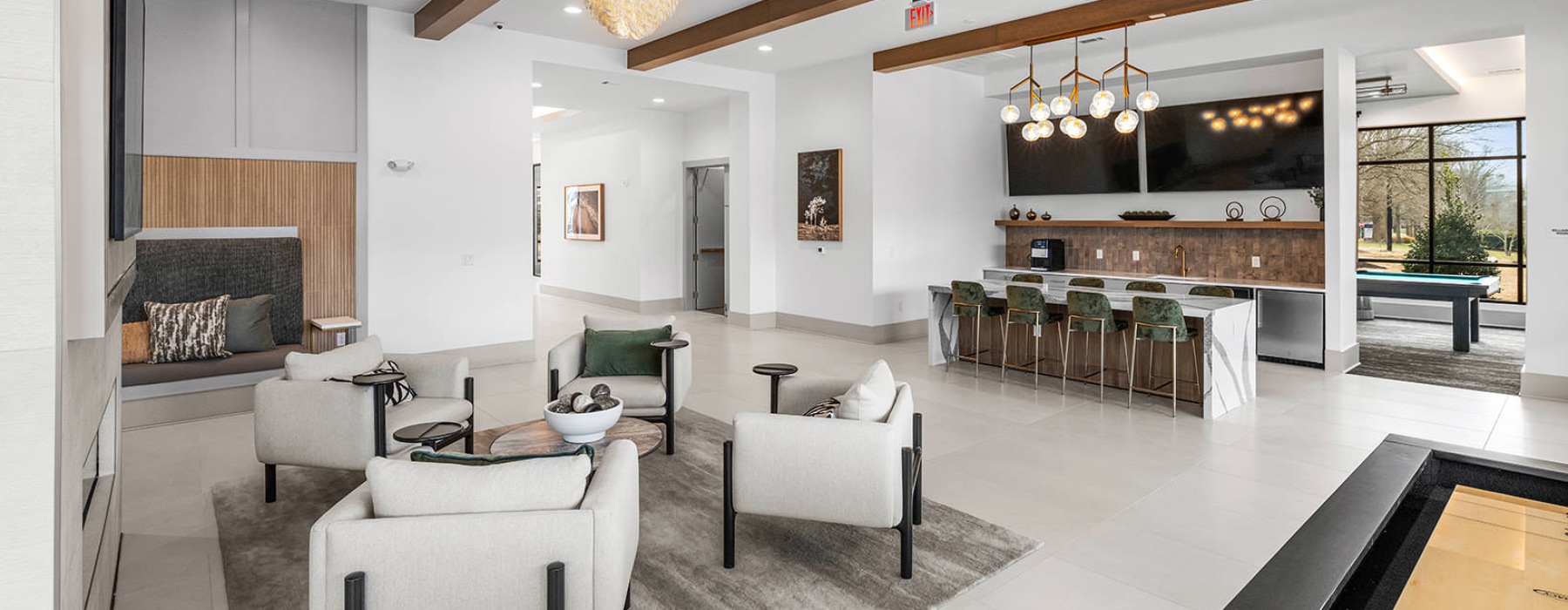 All the comforts of luxury living kitchen and shuffleboard table in clubhouse