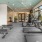 a variety of exercise equipment in well lit gym